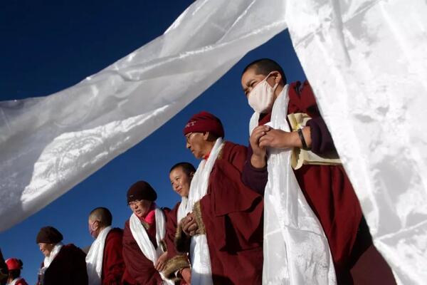 Tibetan monks are offered Khatas at festival